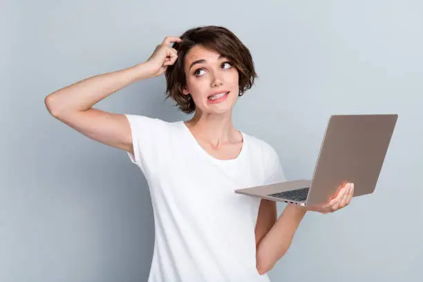 Confused programmer struggling with code on laptop