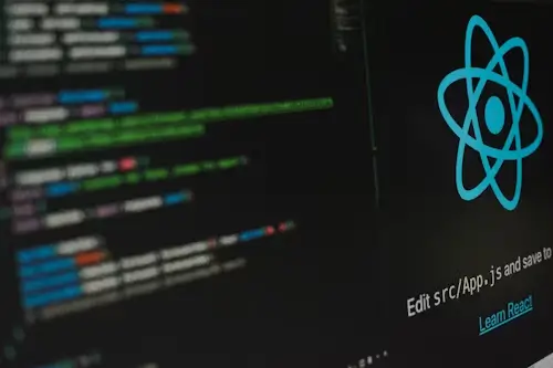 **"React code snippet displayed on a laptop screen"**